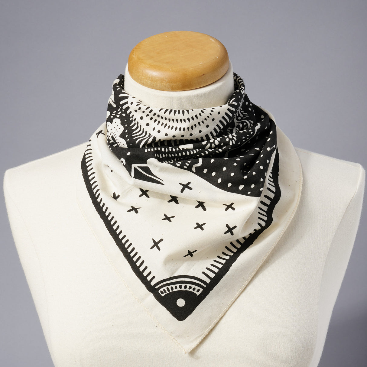 Land & She Folk Bird bandana modeled on a neutral background.