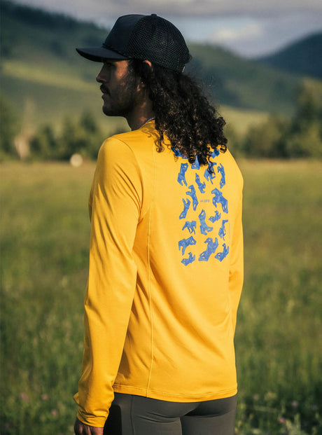 Janji M's Run All Day Long Sleeve in Golden Blue Horses being worn outside.