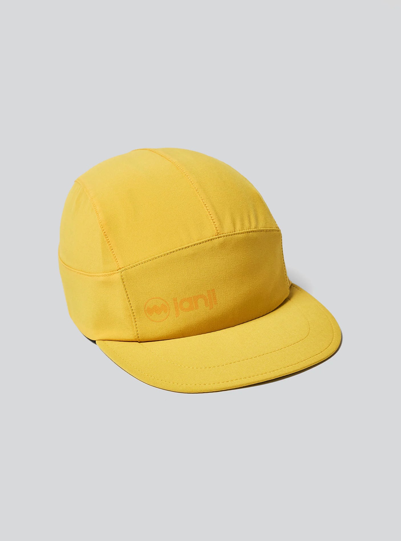 The Janji AFO Hyperlight Cap in Goldenray on a neutral background.