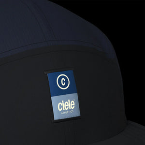 Ciele Athletics PBCap - C-Cube in Ironcast from the front on a dark background showing the reflective detailing.