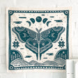 Land & She Luna Moth Bandana on a neutral brick background.