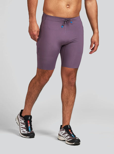 Janji Men's 8" Trail Half Tight in Massif worn by a man on a neutral background.