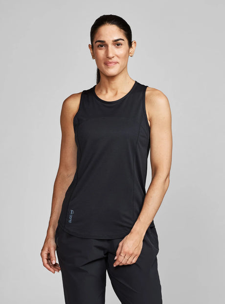 Janji W's Run All Day Tank on a neutral background, worn by a woman.