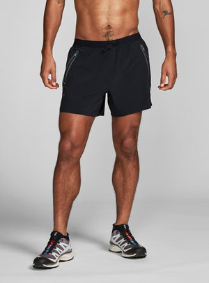 Janji's 5" AFO Middle Short Ultra in Midnight worn by a man on a neutral background.