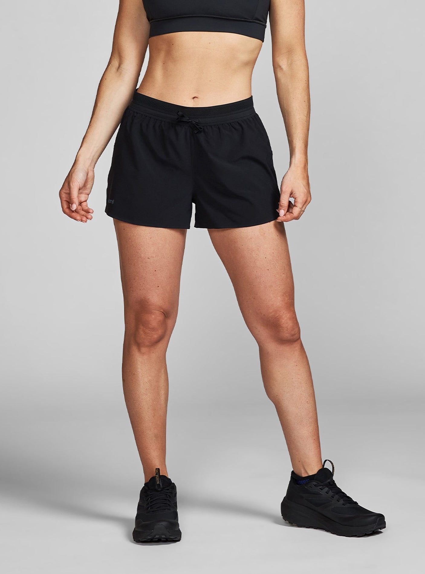 Janji's Women's 3" AFO Middle Short in Midnight being worn by a woman.