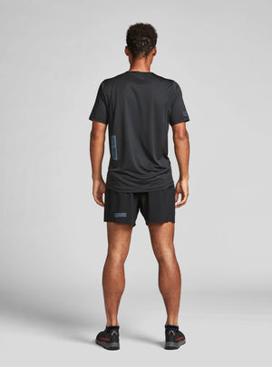 Janji M's Run All Day Tee on a neutral background worn by a man from the rear.