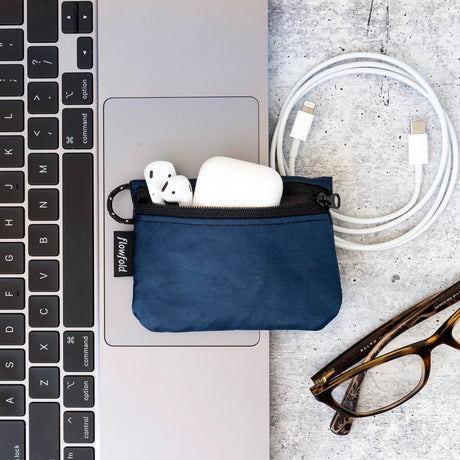 Flowfold Essentialist Mini Zip Pouch in navy on a laptop.