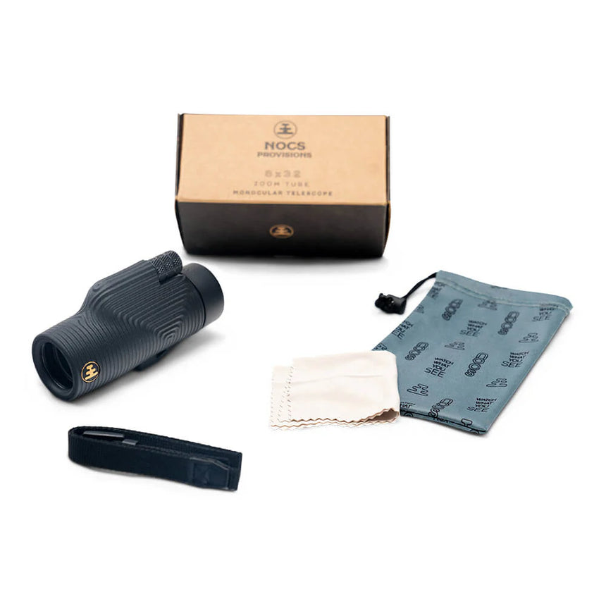 Nocs Provisions Zoom Tube 8x32 Monocular in Obsidian Black on a neutral background showing the strap and pouch that comes with it.
