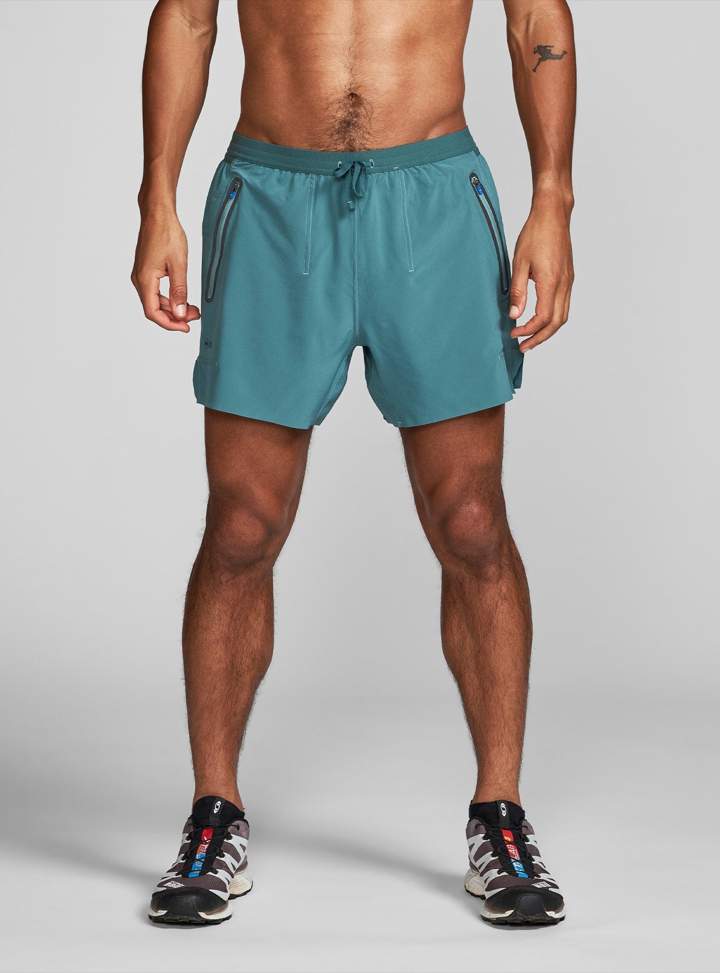 Janji's 5" AFO Middle Short Ultra in Plateau being worn by a man on a neutral background.