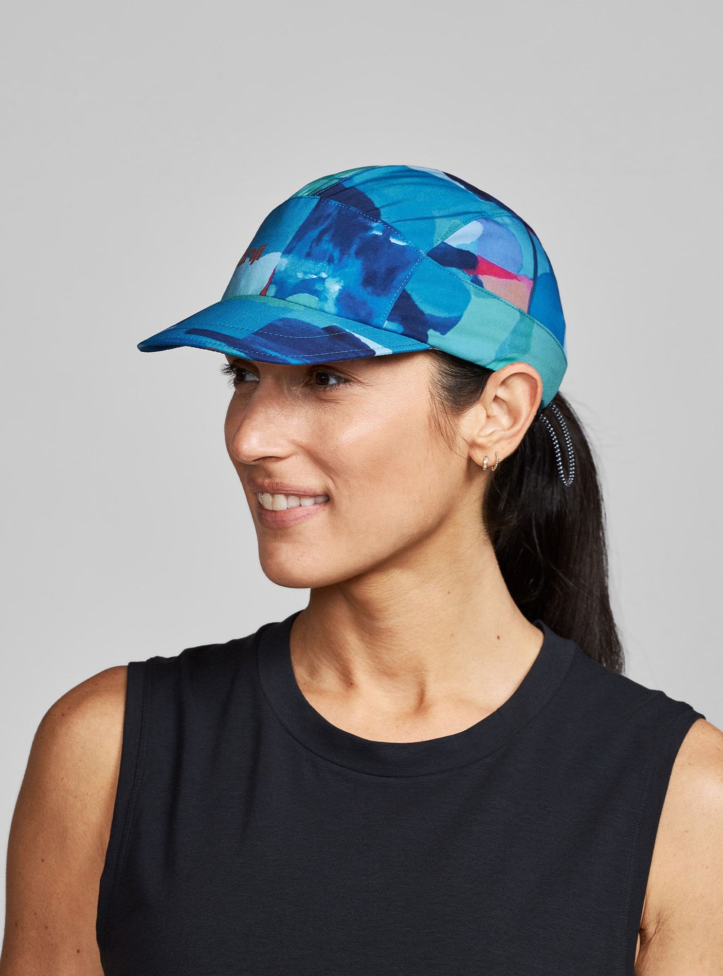 Janji AFO Hyperlight Cap worn by a woman on a neutral background.
