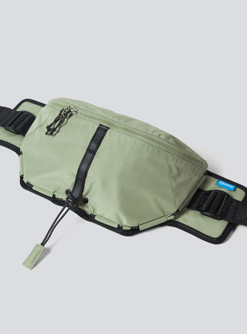 Janji Multipass Sling Bag on a neutral background.