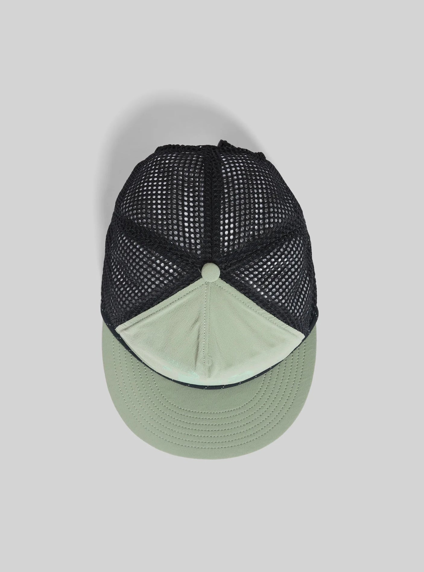 Janji Trailbreaker Hat in Sage Runner on a neutral background from above.