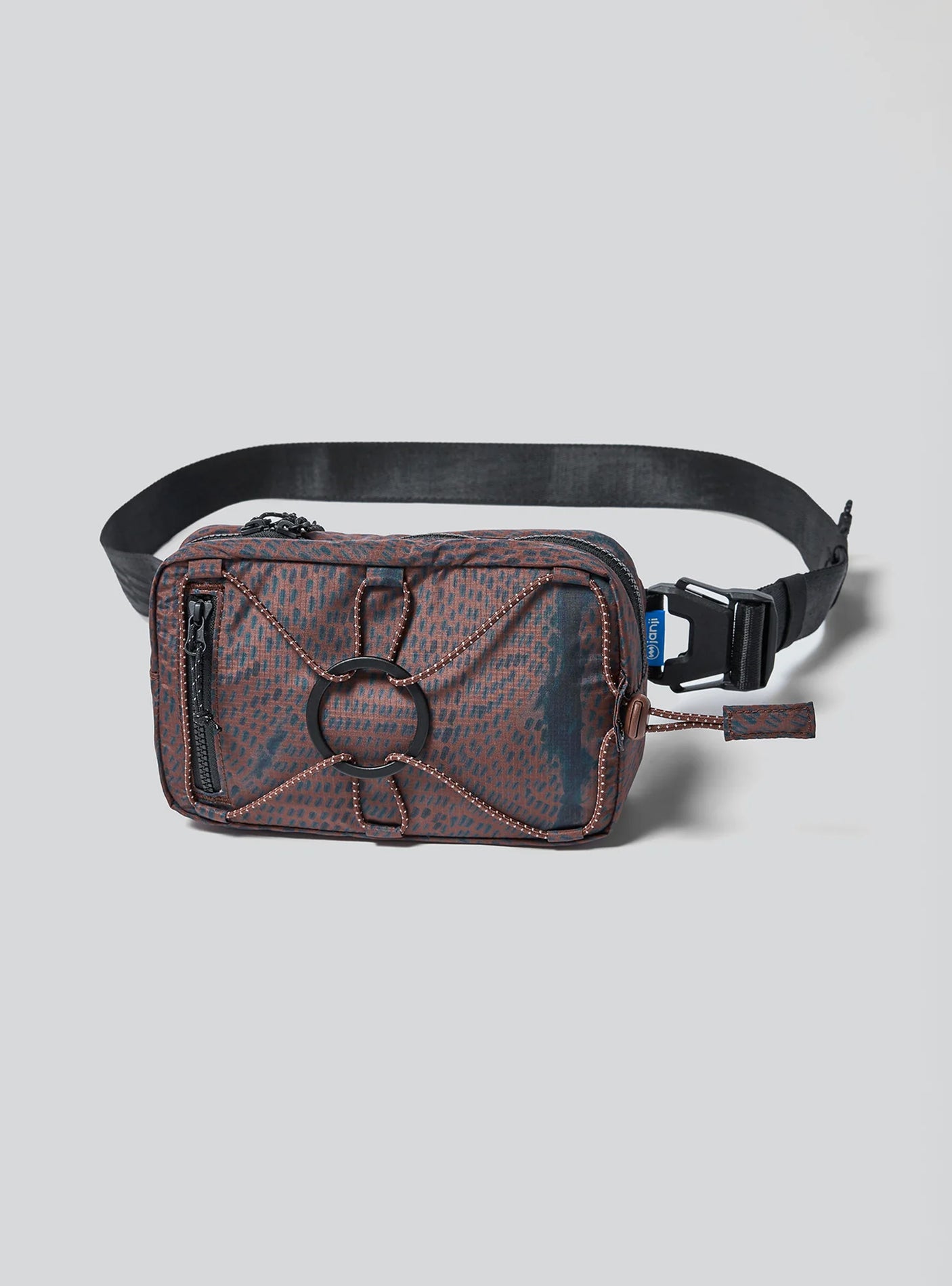 Janji Multipass Mini 1L running sling bag in Shadowlands on a neutral background.