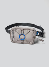 Janji Multipass Mini 1L running sling bag in Silt on a neutral background.