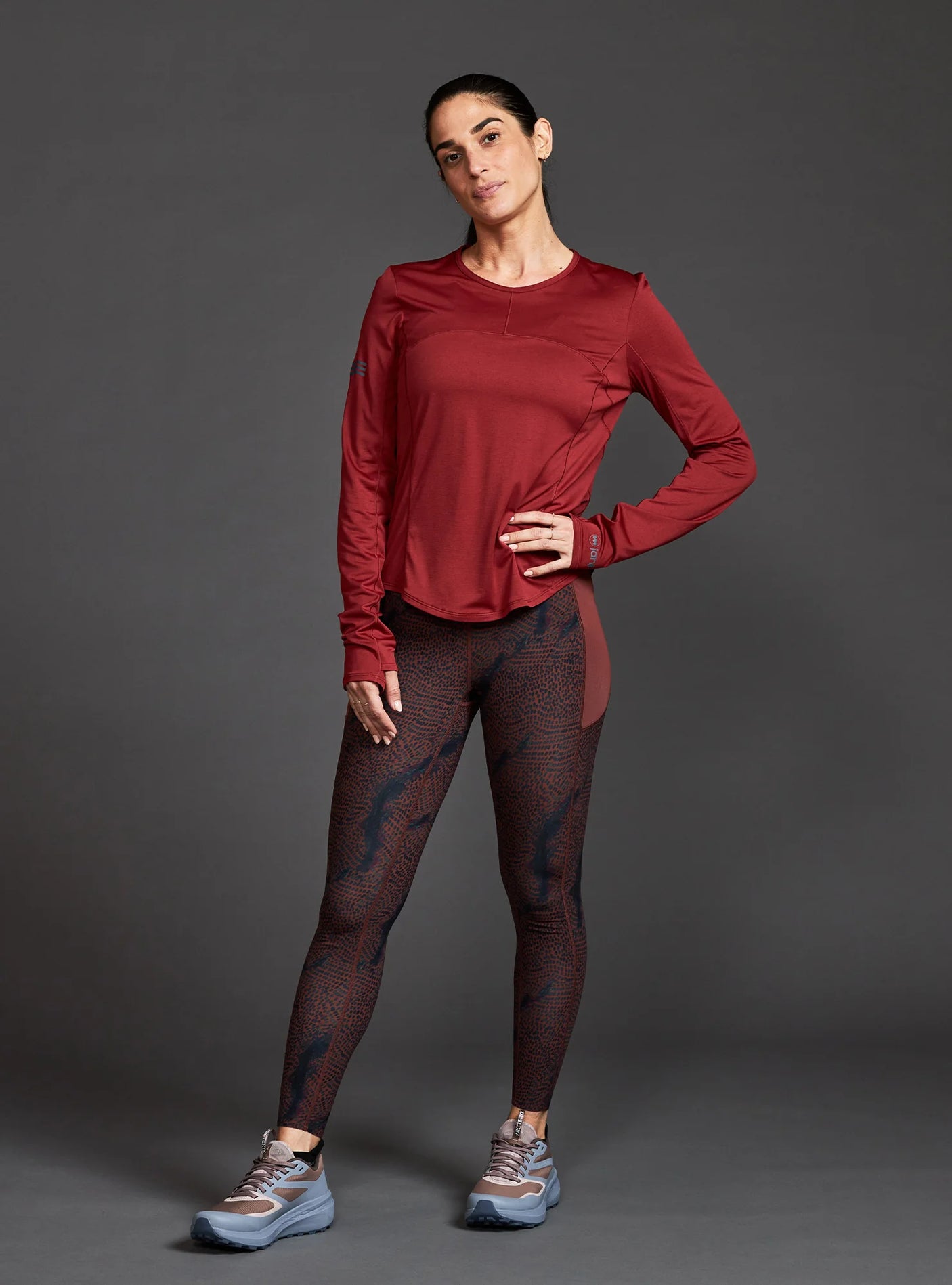 Janji W's Run All Day Long Sleeve in Spice worn by a woman on a neutral background.