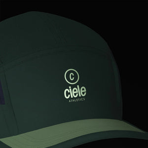 Ciele Athletics ALZCap SC in Spruce on a dark background from the front to show the reflective detailing.