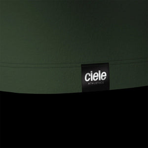 Ciele Athletics M DLYSinglet in Spruce from the rear on a dark background.