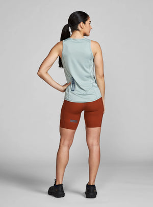 Janji W's Run All Day Tank on a neutral background, worn by a woman and showing the reflective detail on the rear.