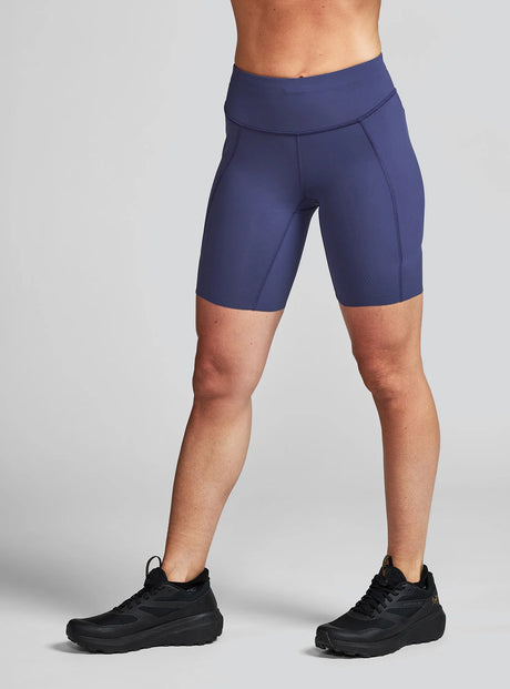 Janji's Women's 7" Pace Short in Thunderstorm being worn by a woman on a neutral background.