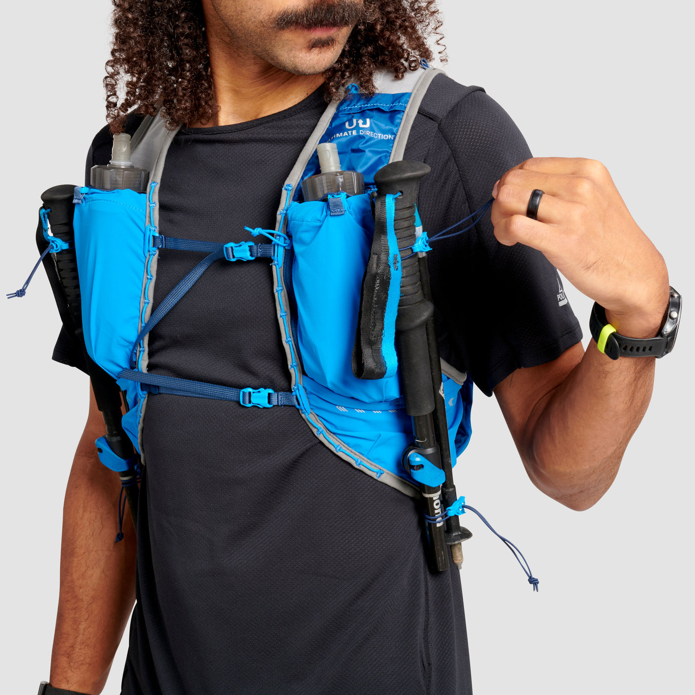 The Ultimate Direction Ultra Vest 6.0 on a neutral background being worn by a man.